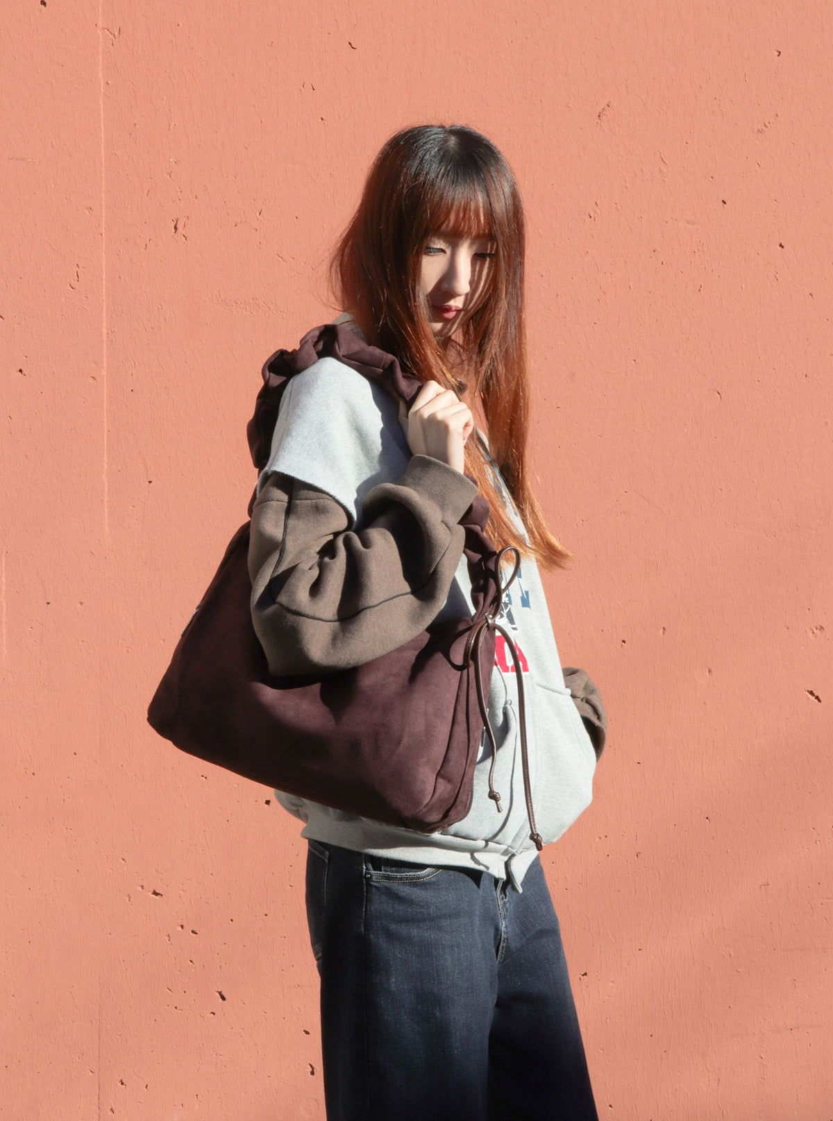 Model wearing Balla Chocolate ruched shoulder bag
