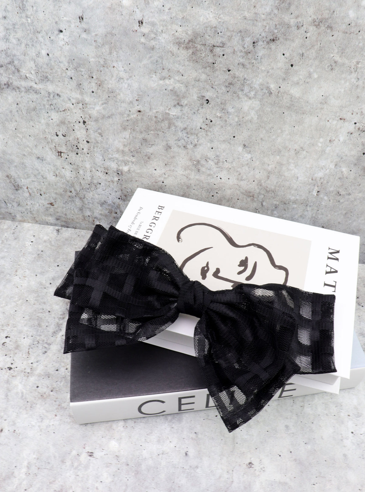 Jenda Black checkered mesh bow clip in a styled setting