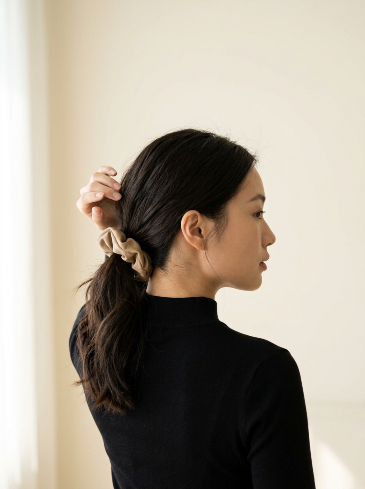 Model wearing Jiselle Beige faux leather scrunchy in a low ponytail