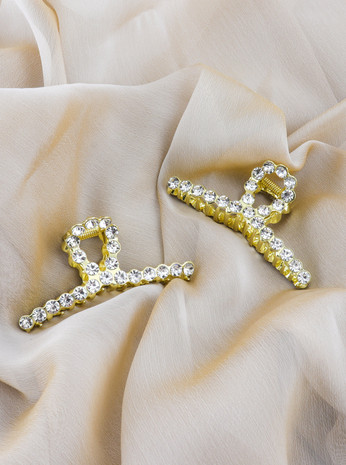 Styled detail of Janina gold claw clip with cubic zirconia