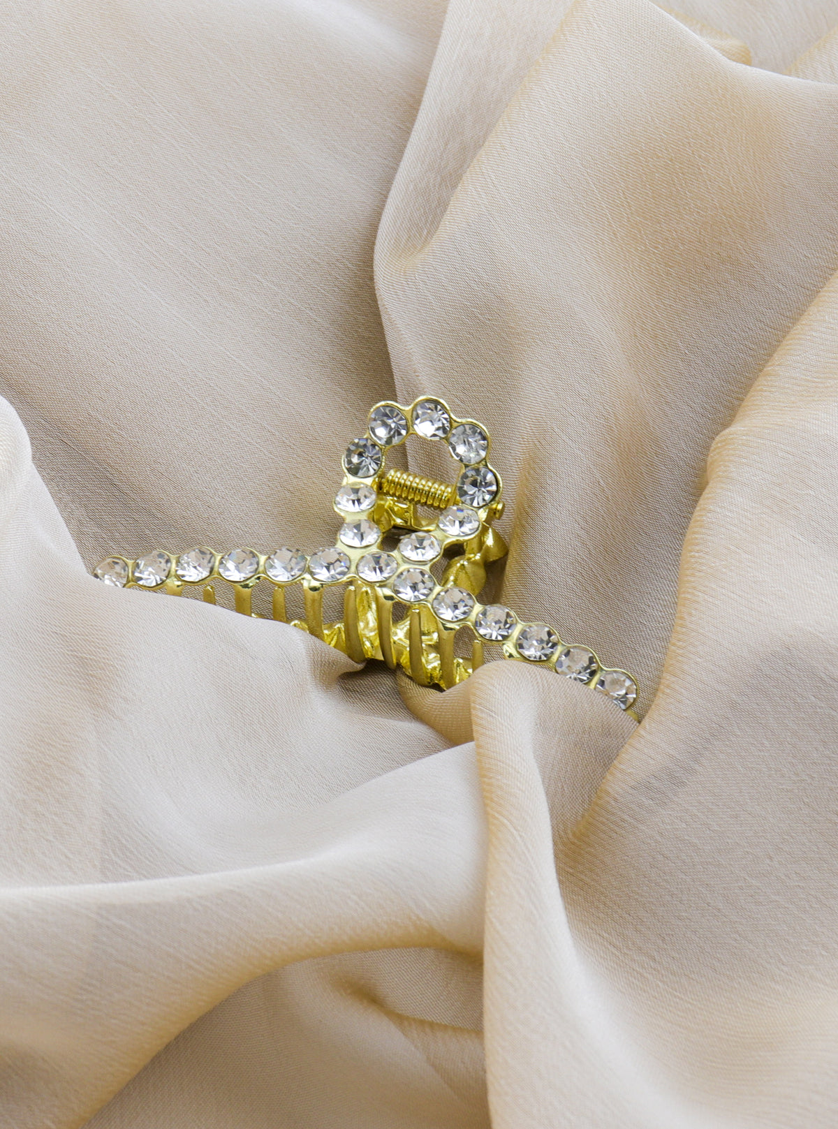 Janina gold crystal claw clip in a styled setting