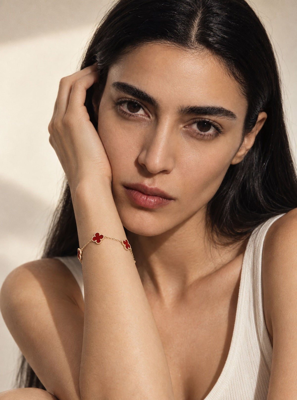 Model wearing Amma Gold Wine clover bracelet