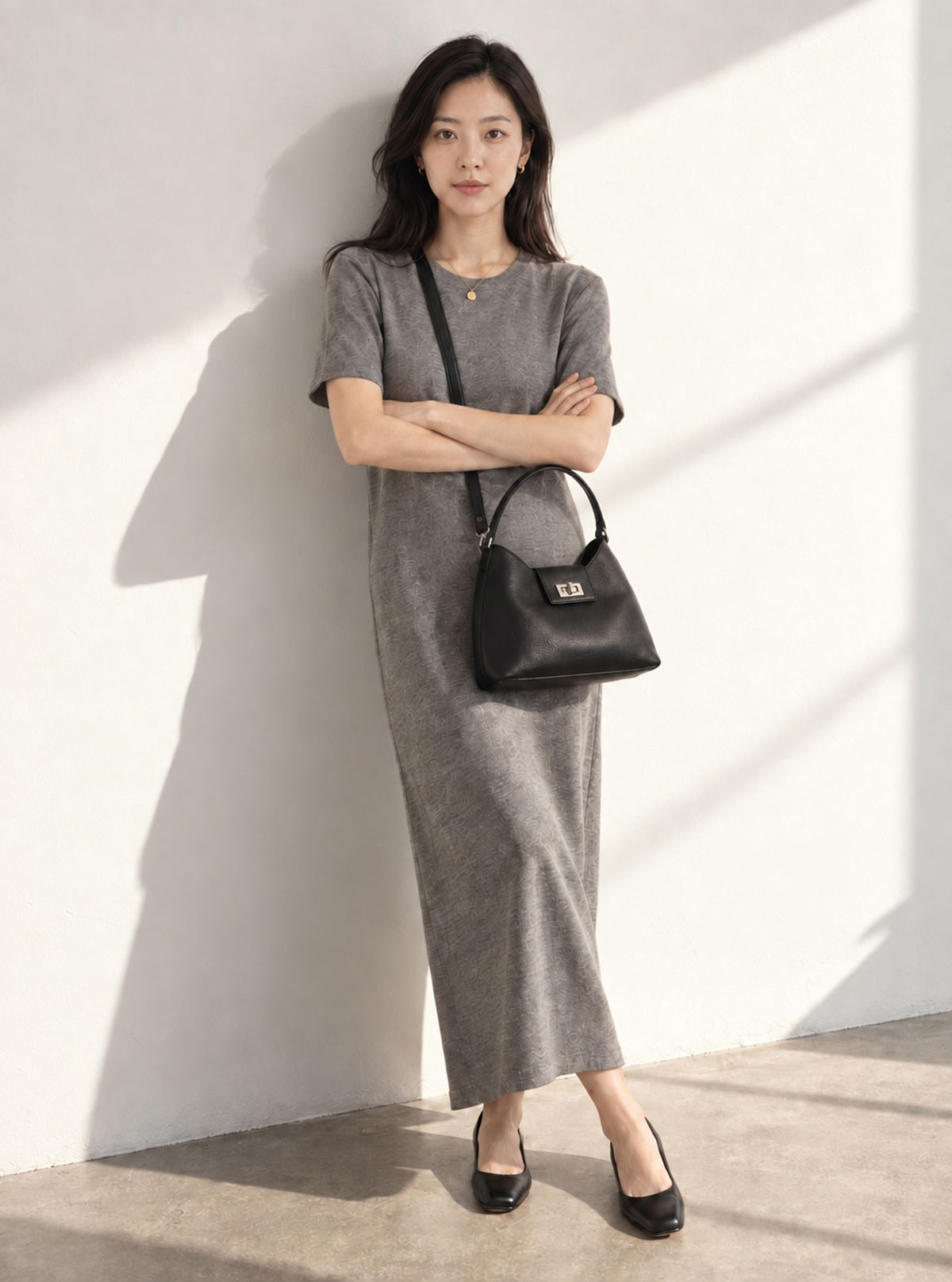 Model carrying Bettine Taupe top handle crossbody bag