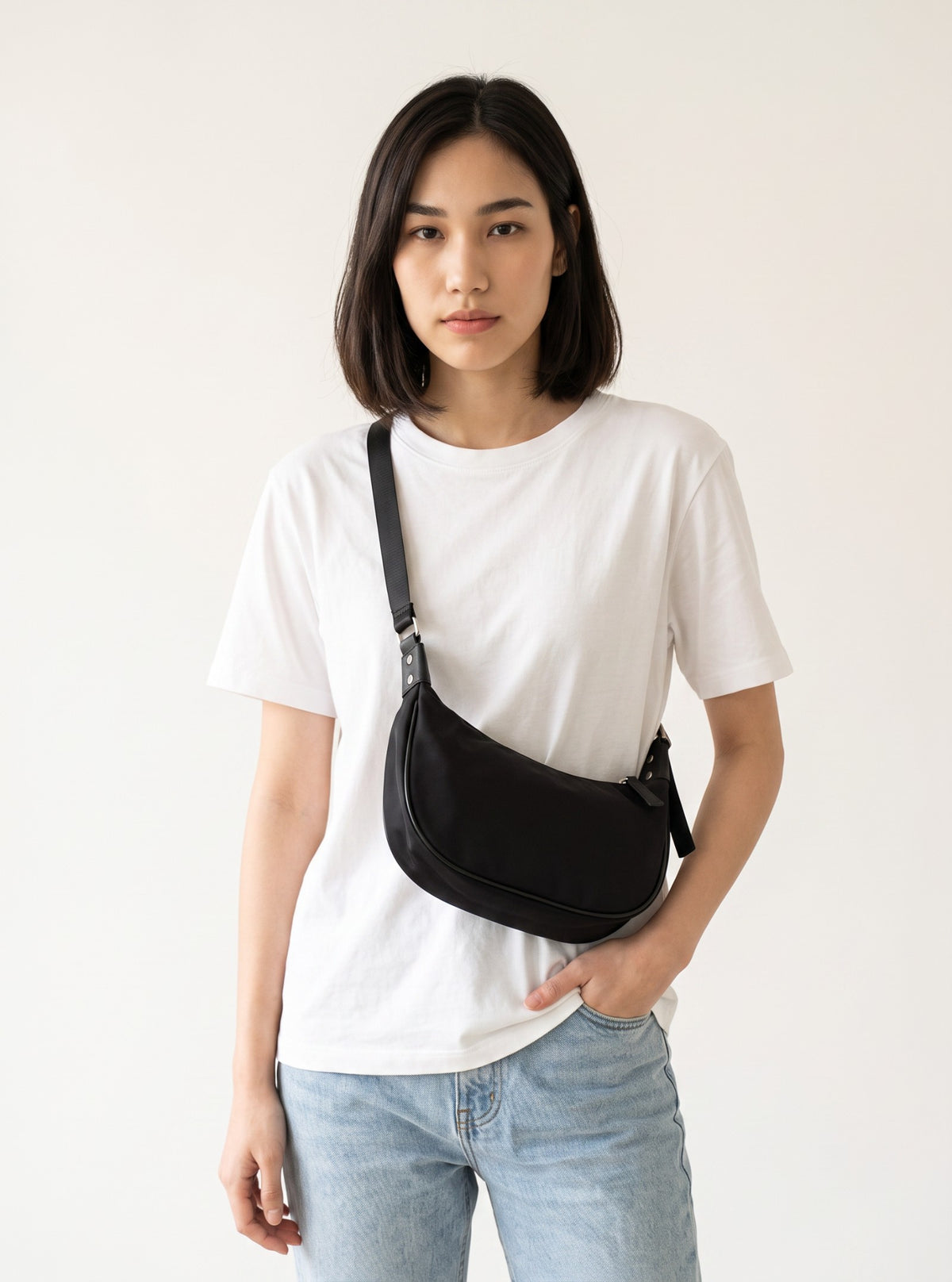 Model wearing Bryd black shoulder bag