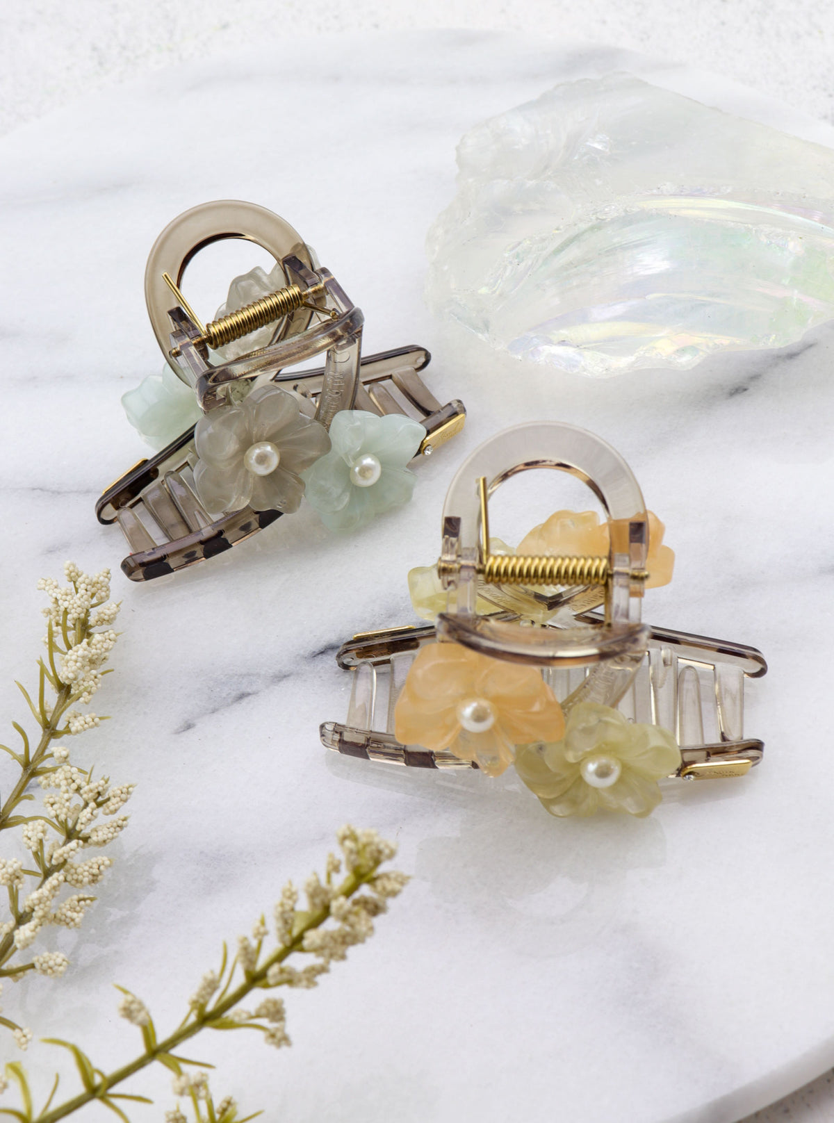 Top view of Jakei floral hair claws in mint peach and blue grey
