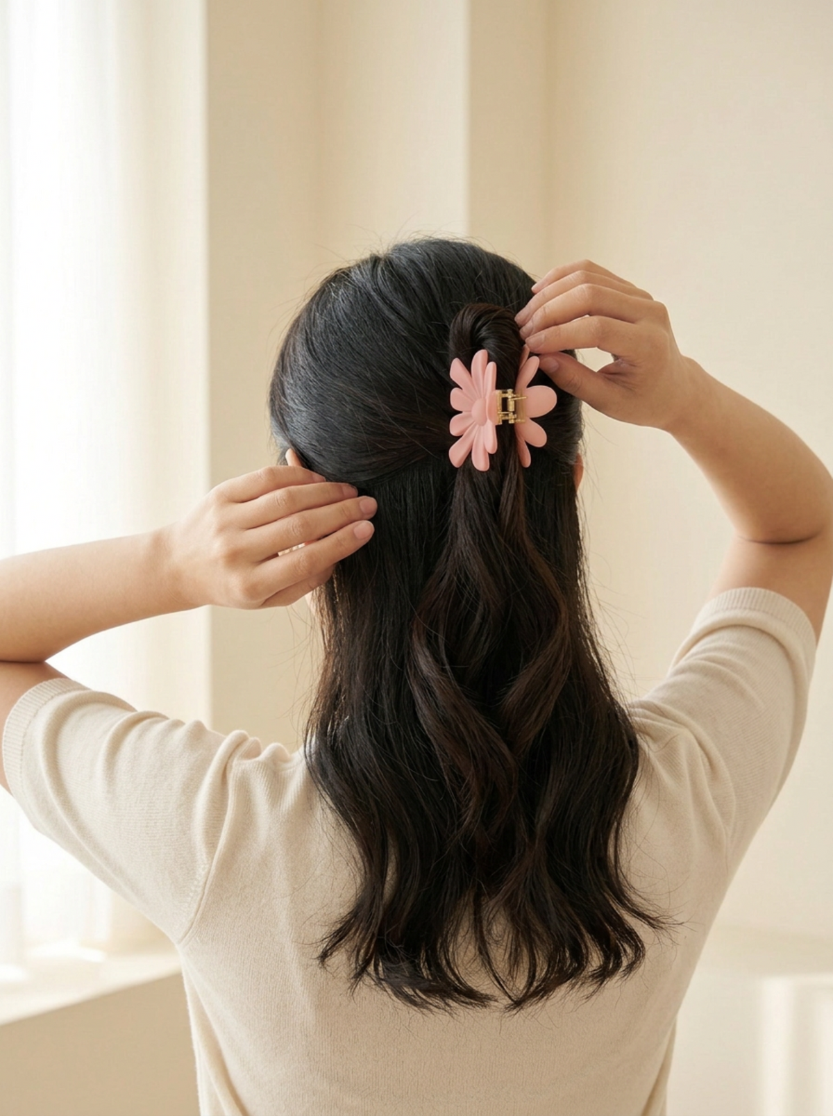 Model wearing Jalee ice pink daisy hair claw in a half-up style