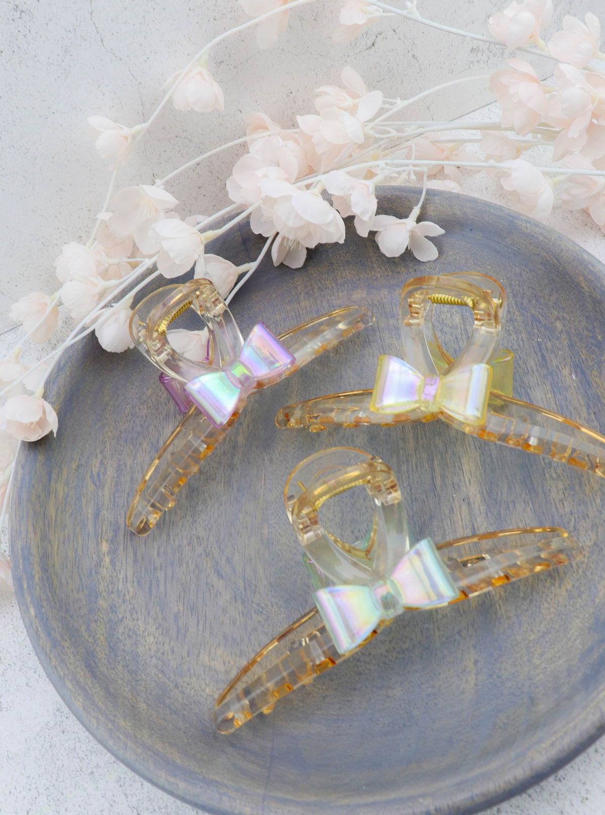 Jansa translucent hair claws with iridescent bow accents