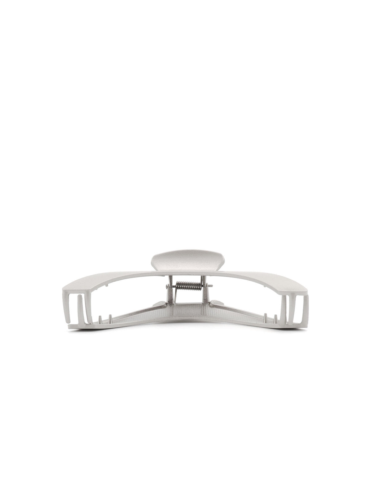 Detail view of Jila matte silver hair claw and curved silhouette