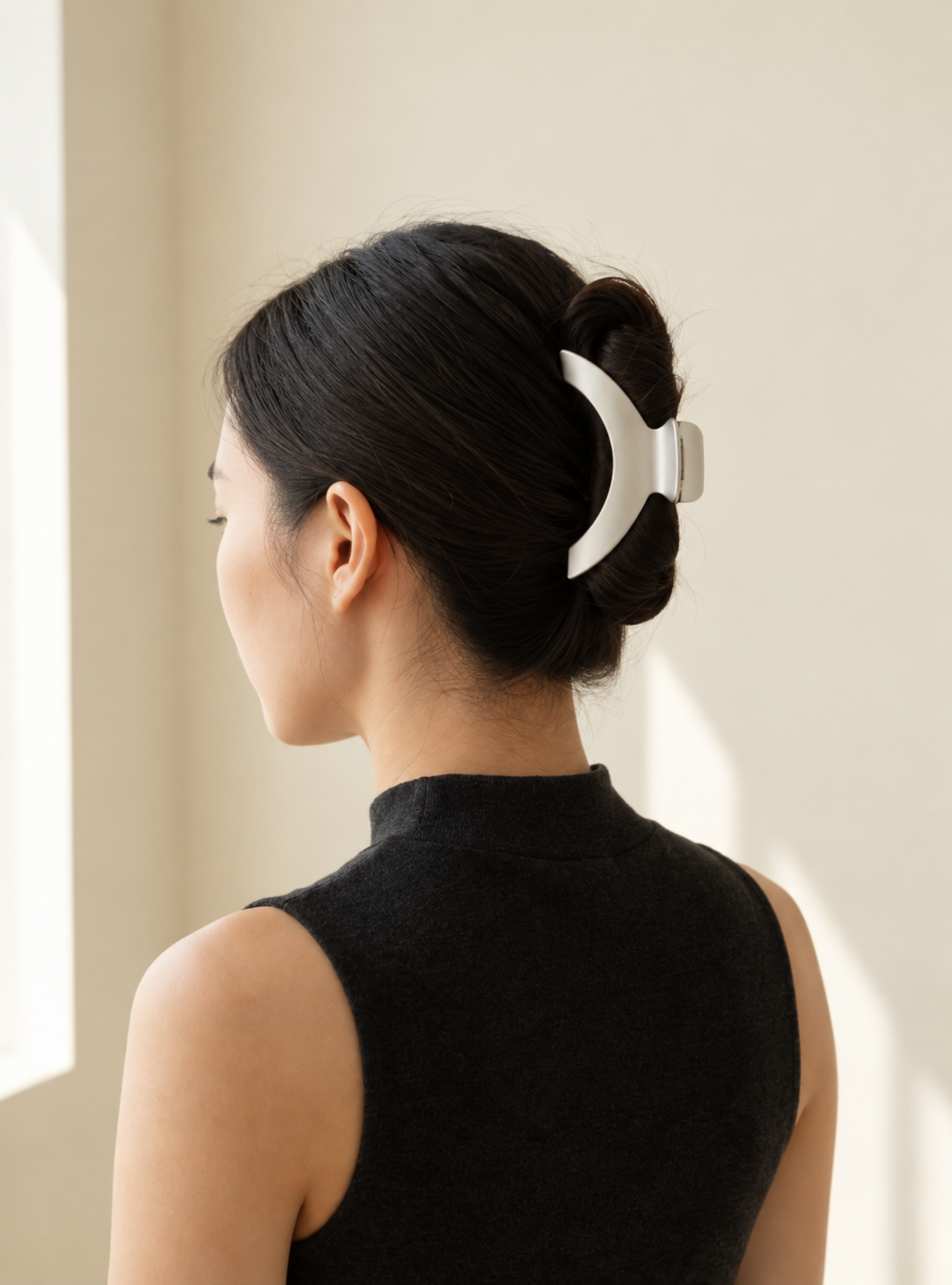 Model wearing Jila matte silver hair claw in an updo