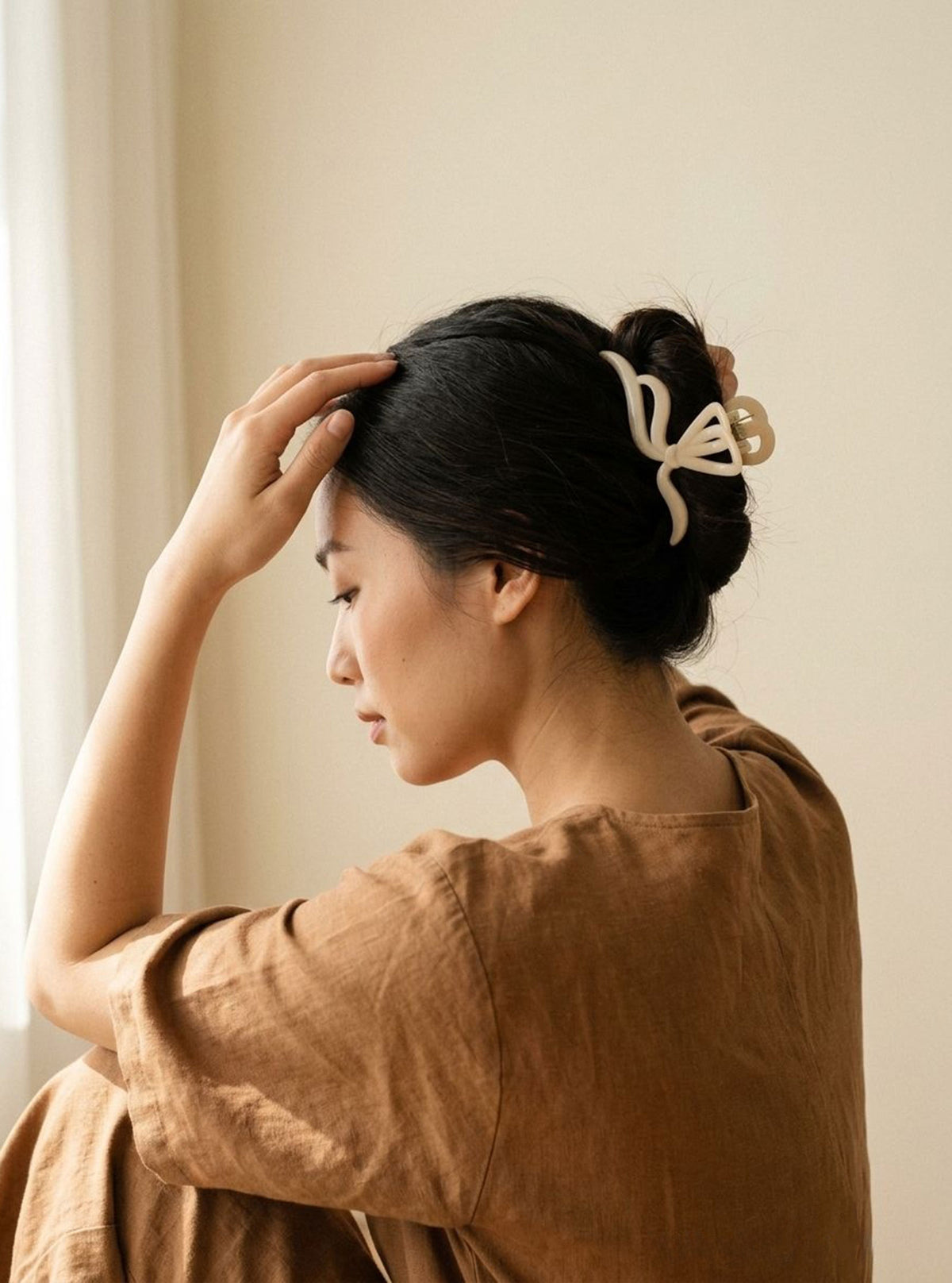 Model wearing Jolanthe ivory hair claw in an updo