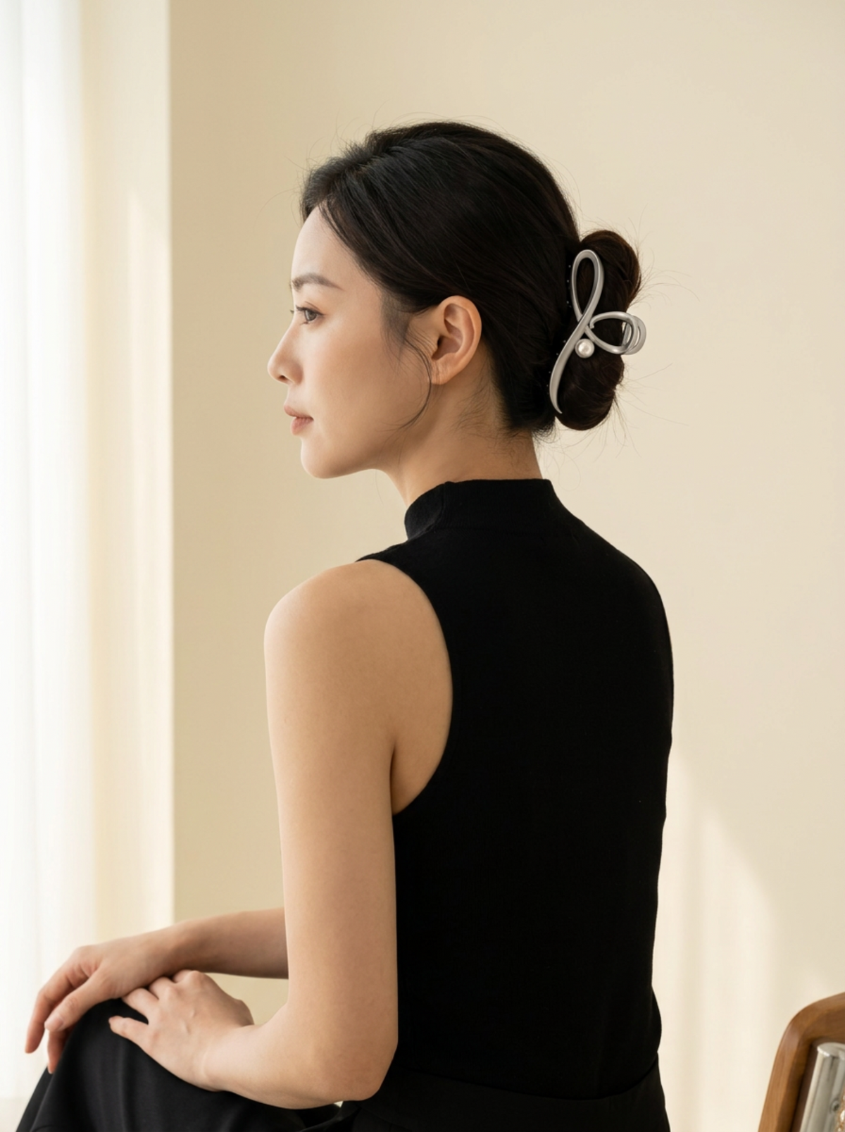 Model wearing Jomena grey sculptural hair claw in an updo