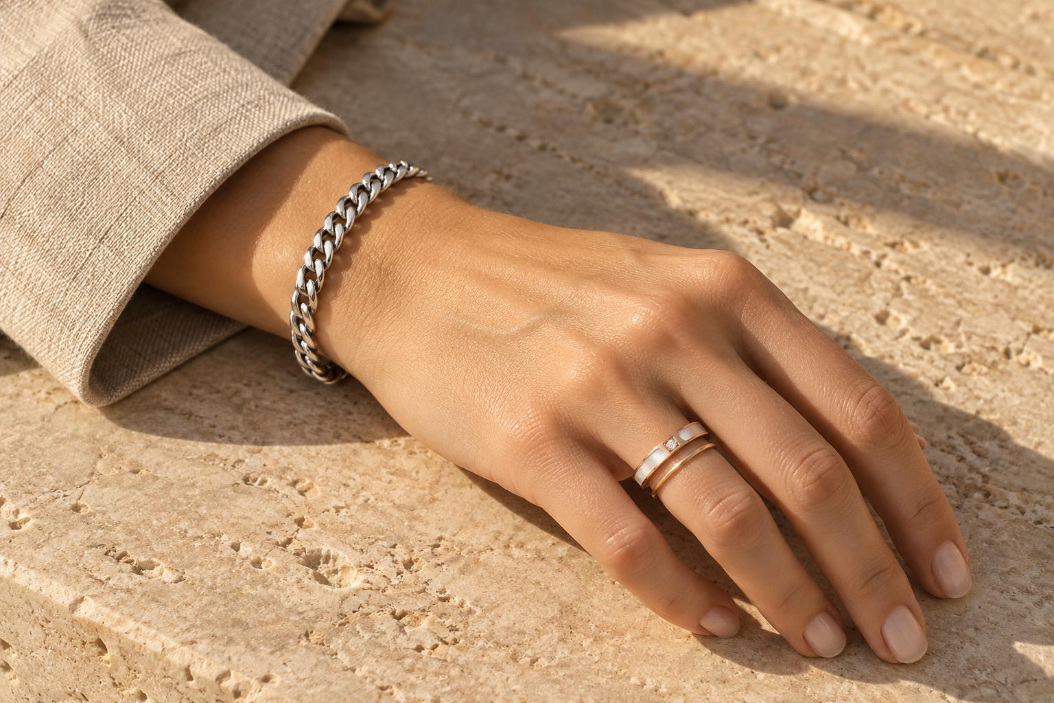 Abram structured chain bracelet and Abigail pearl shell ring worn with an oat-beige blazer cuff